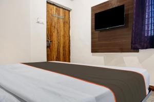 PhūrsungiにあるCollection O Aachal Hotel & Lodgingのベッドルーム1室(ベッド1台、テレビ、ドア付) +23枚の写真