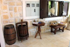 a room with two wooden wine barrels and a table at Apartments by the sea Sucuraj, Hvar - 6732 in Sućuraj