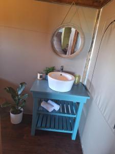 a bathroom with a sink and a mirror at Trekosglamping luxury tents 