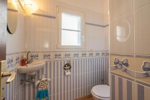a blue and white bathroom with a sink and a toilet at Au Paradis Des Hotes - Chambre Ile in Fouras +13 photos