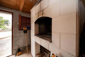 a brick fireplace in a room with a window at Apartments with parking space Savar, Dugi otok - 12762 in Brbinj