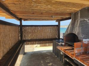 a view of the beach from the inside of a building at Secluded fisherman's cottage Cove Prnjica, Pag - 12620 in Kolan