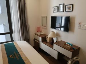 a hotel room with a bed and a tv at Hoan Kiem Old Quarter Hotel Alley 22 Hang Voi in Hanoi