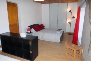 a bedroom with a bed and a dresser in it at Gîte du Lieu Piquot in Gréville-Hague