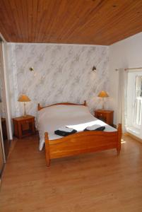 a bedroom with a bed and two lamps on tables at Gîte du Lieu Piquot in Gréville-Hague +4 photos
