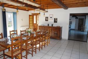 a kitchen and dining room with a table and chairs at Gîte du Lieu Piquot in Gréville-Hague