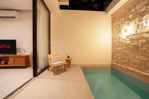 a house with a swimming pool in the middle of a room at Sawo Villa Canggu - Private Brand New 2BR Villa in Canggu