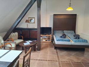 a bedroom with a bed with two teddy bears on it at Apartmán Coralina in Zvolen