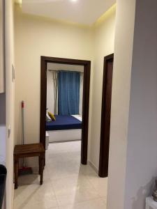 a bedroom with a blue bed and a mirror at Quiet HOME in Hurghada