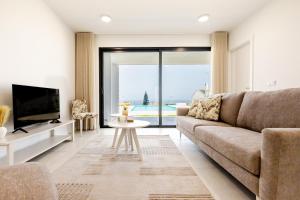 a living room with a couch and a tv at Vale Furado Sea & Nature - BY SCH - B in Vale Furado