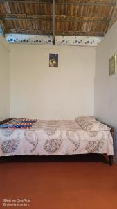 a bedroom with a bed in a white wall at Verdant Vagamon Farm House in Vagamon +51 photos