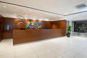 a lobby with a reception desk and paintings on the wall at UC Hall Residence in Nicosia +28 photos