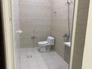 a bathroom with a toilet and a glass shower at شقق المصيف الفندقيه in Hafr Al-Batin