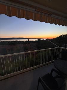 a balcony with a view of the sunset at Apartma Roberto - Ankaran in Ankaran +1 photo