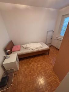 a small room with a bed and a desk at Apartma Roberto - Ankaran in Ankaran