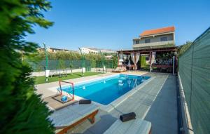 a swimming pool in a yard with a house at Luxury villa with a swimming pool Split - 20334 in Solin