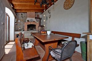 a dining room with a table and a fireplace at Family friendly house with a swimming pool Grizane, Crikvenica - 24302 in Grižane