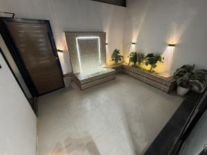 an overhead view of a bathroom with potted plants at سويت بني معن in Al Hofuf