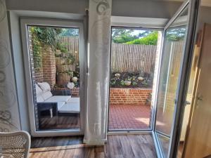 a sliding glass door leading to a patio at Ferienwohnung Am Heimathof in Dorsten