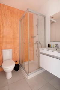 a bathroom with a shower and a toilet and a sink at UC Hall Residence in Nicosia