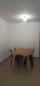 a wooden table with four chairs in a room at Casa Carmen in Serón +5 photos