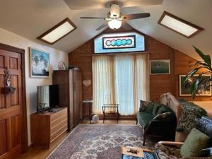 a living room with a couch and a ceiling fan at Vacation Rental with Spa and Pool on Winery near Healdsburg, California in Ingram