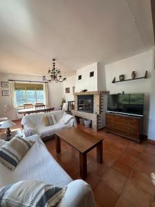 a living room with two couches and a fireplace at Casa Rural El Olivo in Alatoz