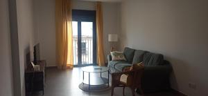 a living room with a couch and a glass table at Casa Carmen in Serón
