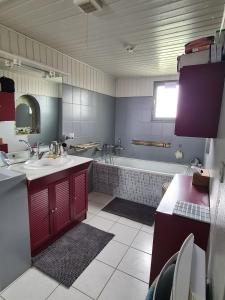 a bathroom with a sink and a bath tub at Maison sur Ile de Noirmoutier in LʼÉpine