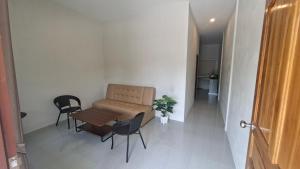 a room with a table and chairs and a couch at Chamim Apartments Koh Lanta ชามิม in Phra Ae beach +36 photos