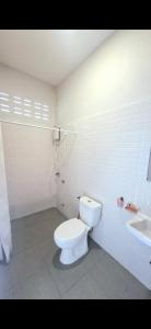 a bathroom with a white toilet and a sink at Chamim Apartments Koh Lanta ชามิม in Phra Ae beach +36 photos