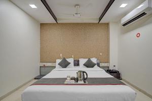 a bedroom with a large white bed with aigiligiligiligiligiligiligil at Hotel Marina FREE Airport Drop in New Delhi +24 photos