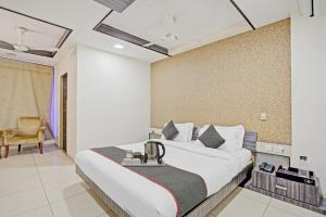 a hotel room with a bed and a chair at Hotel Marina FREE Airport Drop in New Delhi