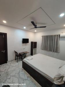 a bedroom with a large bed and a table at Hotel AI Near Shalimar railway station in Howrah +4 photos