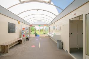 a hallway of a school bathroom with a ceiling at New! Guesthouse Eindeloos in 't Zand