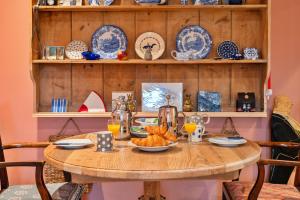 a wooden table with a plate of food on it at Finest Retreats - Church House Annexe in Highbray