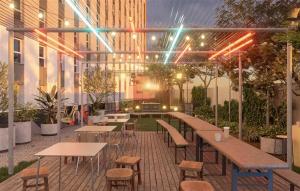 a patio with tables and chairs and a building at Micampus Braga Student Residence in Braga