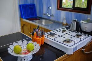 a kitchen with a counter with a sink and a counter top with a counter top at sunny's homestay in Singatoka +34 photos