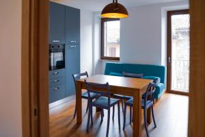 a dining room with a wooden table and chairs at GUBBIO LIVING - by Angeloni in Gubbio +20 photos