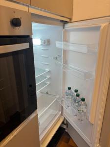 an empty refrigerator with bottles of water in it at Minerva in Viareggio