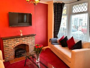 a living room with a couch and a fireplace at Private Rooms in Portsmouth in Portsmouth