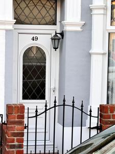 a black fence in front of a house with a door at Private Rooms in Portsmouth in Portsmouth