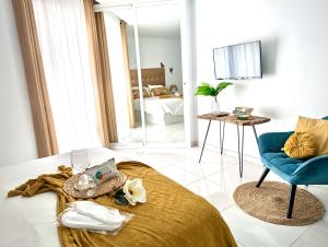 a living room with a bed and a blue chair at Luxury Bahia Sea Views by Deihu Experiences in Los Cristianos +40 photos