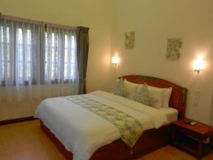 Postel nebo postele na pokoji v ubytování Eureka Villas Siem Reap