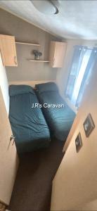 En eller flere senge i et værelse på Golden Gate Holiday Centre