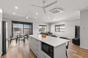 a kitchen and living room with a couch and a table at Broome Villa Oasis in Broome