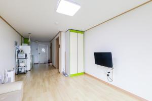 a living room with a flat screen tv on the wall at 온담펜션 