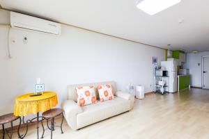 a living room with a white couch and a table at 온담펜션  +2 photos