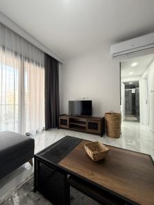 a living room with a coffee table and a television at Riverside Life Residence in Iskele +75 photos