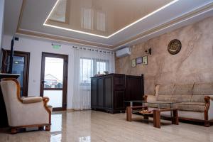 a living room with a couch and a table at Pensiunea Vis Braila in Vărsătura
